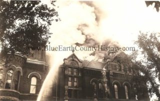 Black and white image of water from a hose spraying at the Mankato High School during the Mankato High School Fire 1941