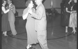 Three couples dancing in the 1940s. Black and White negative image.