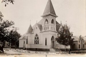 First Presbyterian Church c. 1908 in Lake Crystal. Black and white image with a few trees.